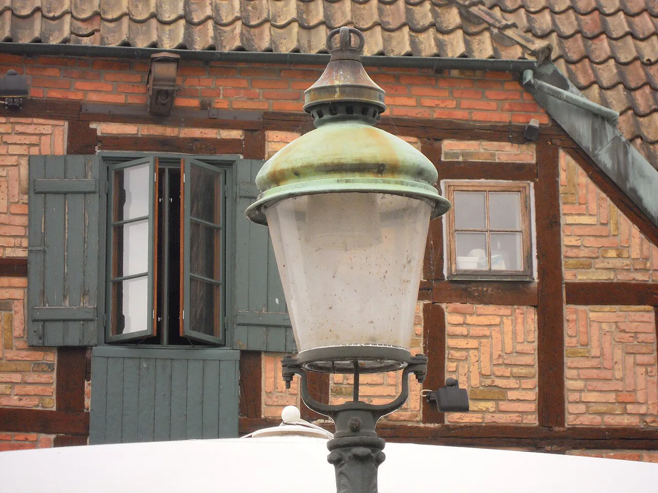 A lamp and half-timbered façade on Lilla Torg, Malmö.