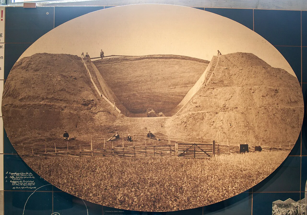 A historic photograph of an excavated mound in the Gamla Uppsala museum.