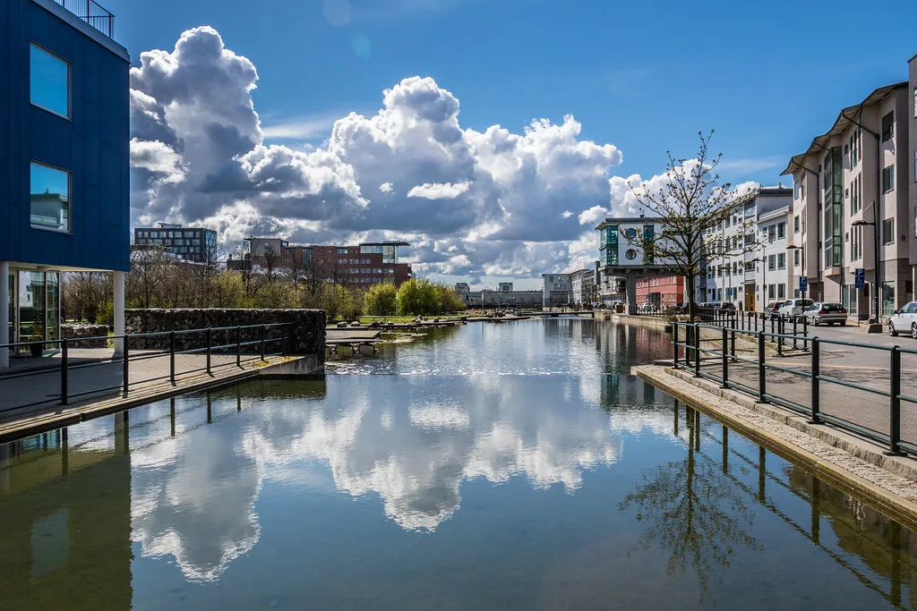 A canal in Malmö reflecting the sky.