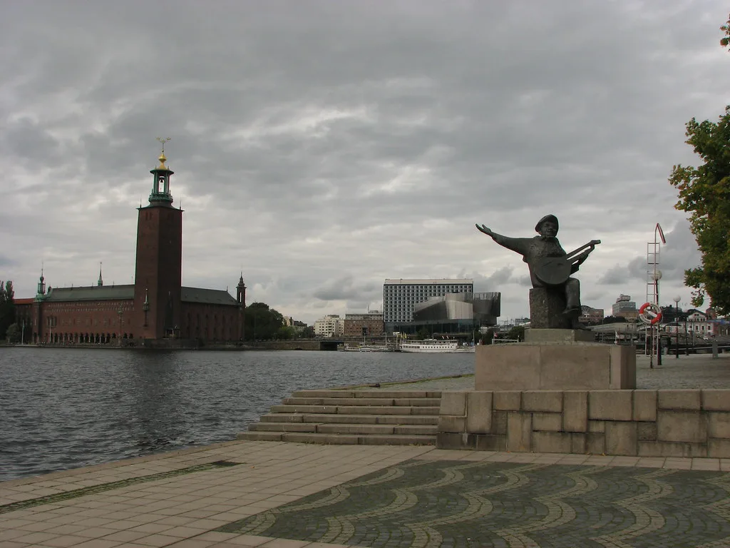 The Evert Taube statue and City Hall from Riddarholmen, Stockholm.
