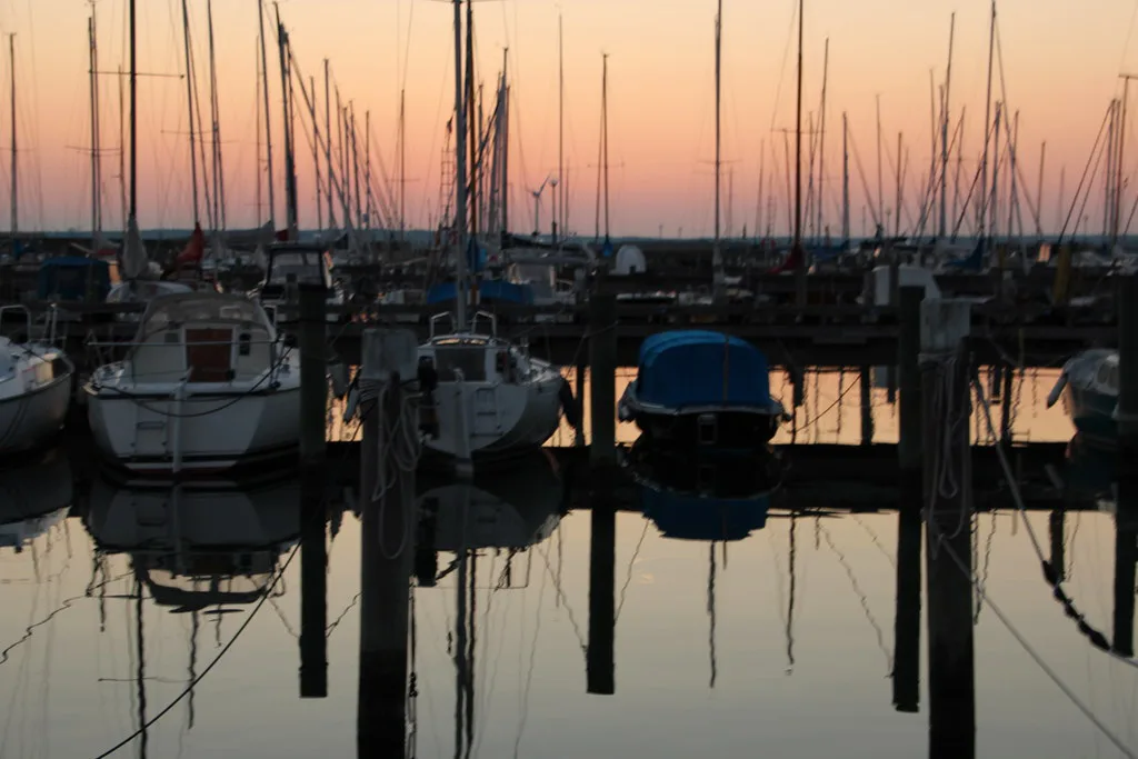 Sailing boats at dusk in a Swedish marina.
