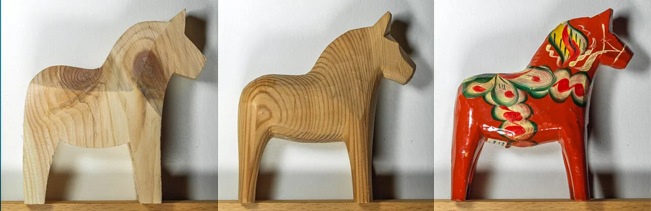 Unpainted and painted Dala horses.